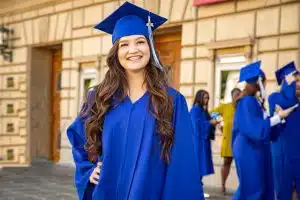 Female high school graduate smiling for the camera.