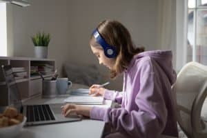 Teenage student distance learning on laptop doing homework