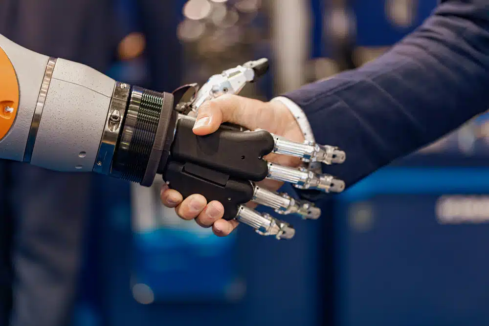 a man shaking hands with a robotic hand