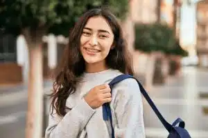 Young middle schooler smiling at the camera.