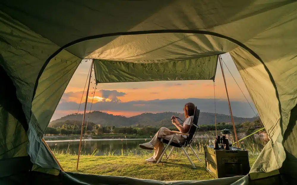 Asian woman travel and camping alone at natural park
