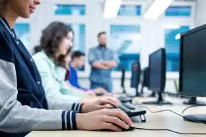 Cropped picture of students using computers in a classroom