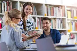 Students talking in a library.