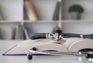 View of a medical book with a stethoscope on top.