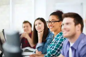 Group of students talking in a room.