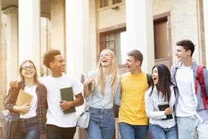 Group of students walking together and smiling.