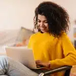 View of a student using her laptop while checking when do SAT scores come out.