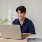 Young student using a laptop.