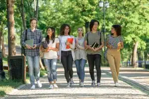 Group of students walking in the campus.