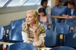 Female student sitting on a podium