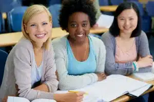 Three happy students smiling