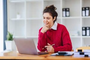 a college student looking at her laptop