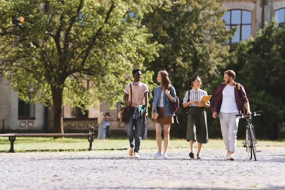 Group of students walking in the campus.