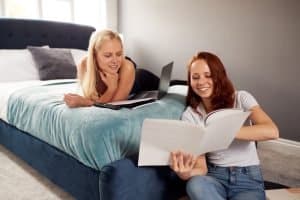 Two women are studying in their dorms.