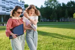 students walk and chat on a college campus