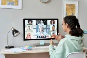 A student sitting in from of her desktop attending a virtual session