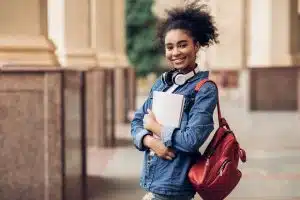 A female student is holding her things.