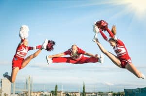 cheerleaders jumping while on practice