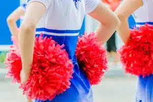 an unidentified cheerleader holding pompoms