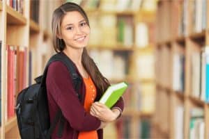 A student with her notebook in the Library