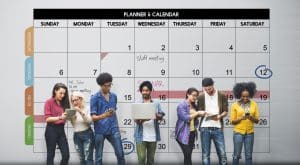 a group of student standing having a background of a calendar