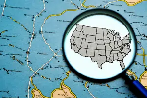 A magnifying glass hovering over a map of the united states