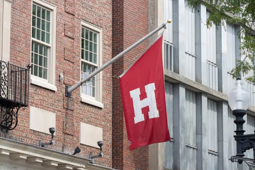 Harvard flag is seen outside the Harvard Cooperative Society (the Coop), a collegiate bookstore on the Harvard University campus in Cambridge, Massachusetts.