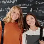 Two girls passionate about math thinking about joining the Mathematical Olympiad Program