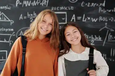 Two girls passionate about math thinking about joining the Mathematical Olympiad Program