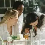 Three girl members of the Science National Honor Society working on a project.