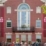 Students relaxing outside a historic campus building at Brown University, highlighting what Brown University is known for: Ivy League academics, open curriculum, and collaborative student life.