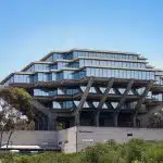 Exterior view of Geisel Library at UC San Diego with trees and blue sky, representing UCSD application deadline.
