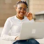 Student reviewing application updates and completing the MIT FUN form on a laptop after submitting college applications