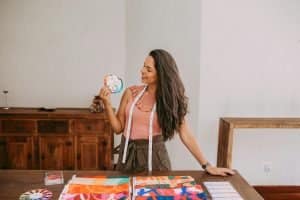 A fashion design student holding swatches of fabric