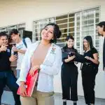 student in white shirt smiling after getting in the youth ambassadors program