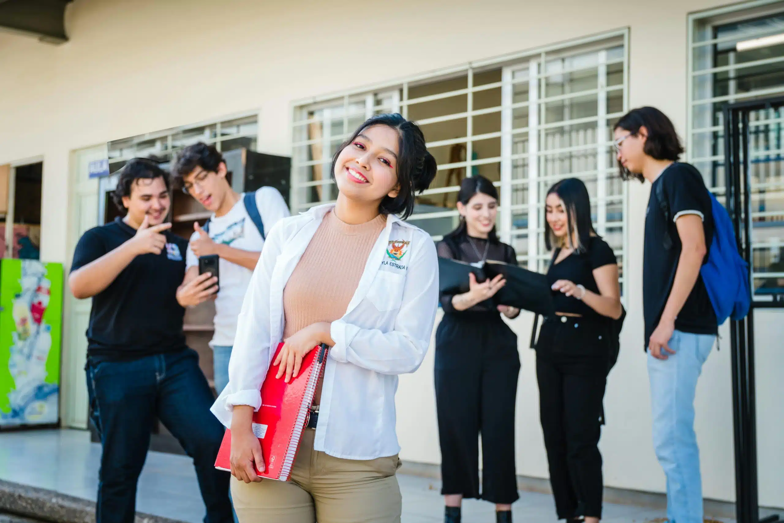 student in white shirt smiling after getting in the youth ambassadors program