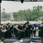 A music ensemble playing in a public concert linked to all state music festival for students wanting to participate