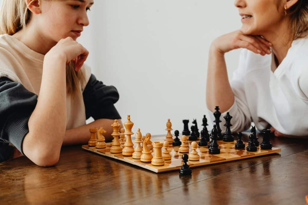 A student and her teacher engrossed in a chess game