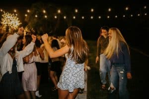 a group of people dancing under twinkling lights