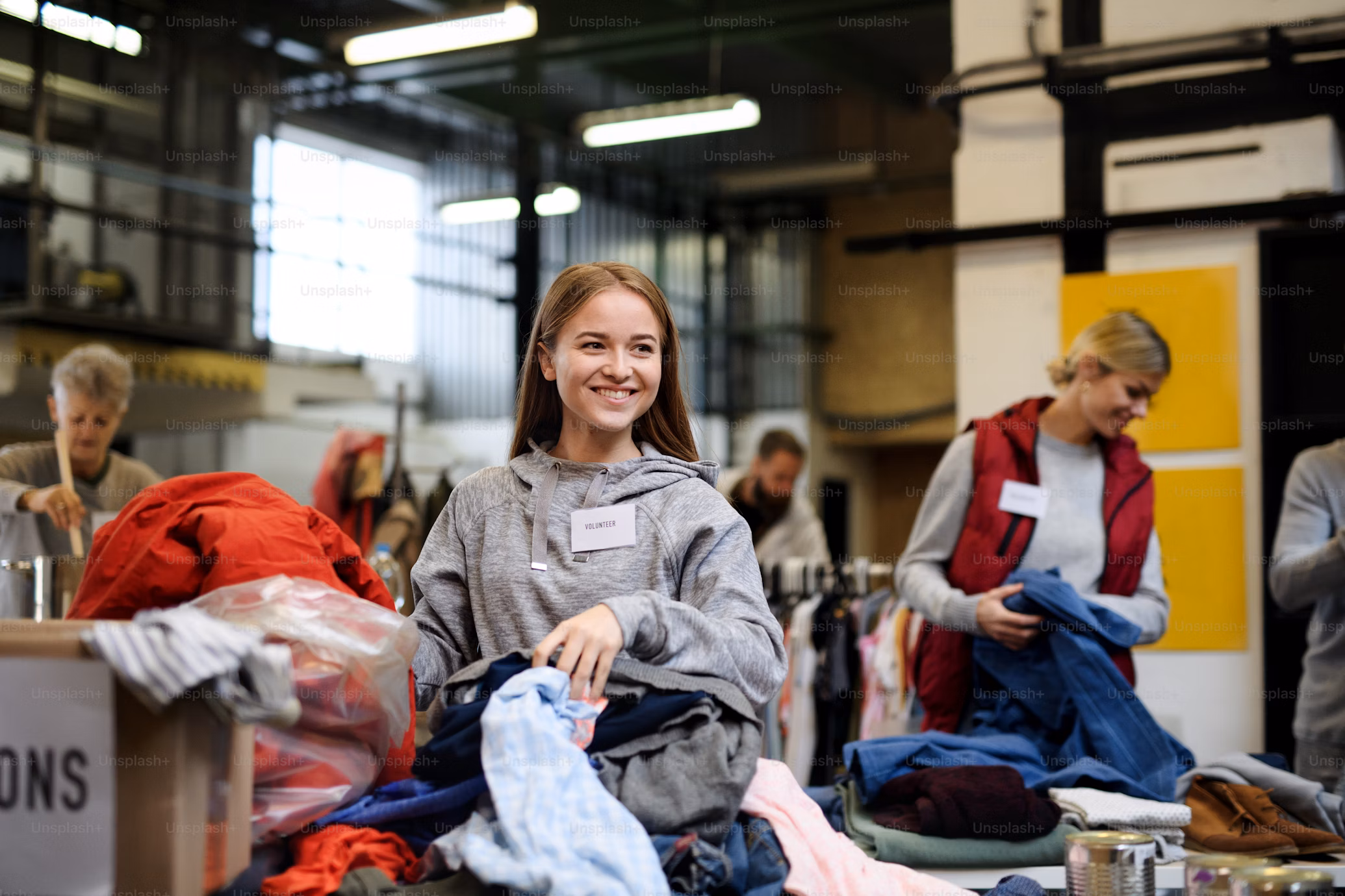 girl volunteer smiling while packing donations