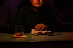 a man sitting at a table with a book