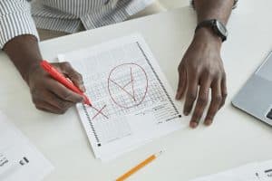 a person marking a test paper