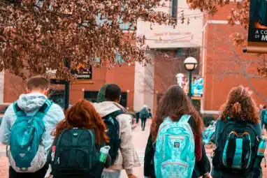 group of students with backpacks walking to new transfer school