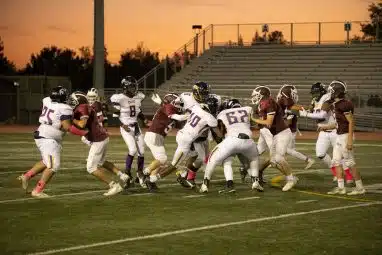 high school athletes playing football