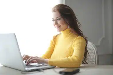 woman in yellow turtleneck sweater wondering how to email admissions office