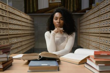 woman in white sweatshirt contemplating about yale founder