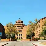 UCLA campus building surrounded by trees under a clear sky, illustrating information about the UCLA application deadline.