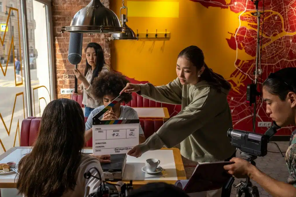 student of the USC School of Cinematic Arts Summer Program shooting a scene in a retaurant