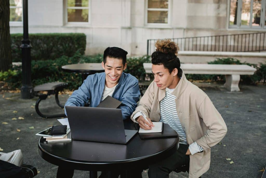 two college students looking at the laptop waiting for when do ucla decisions come out