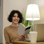 Student smiling while reading for the Columbia Writing Academy
